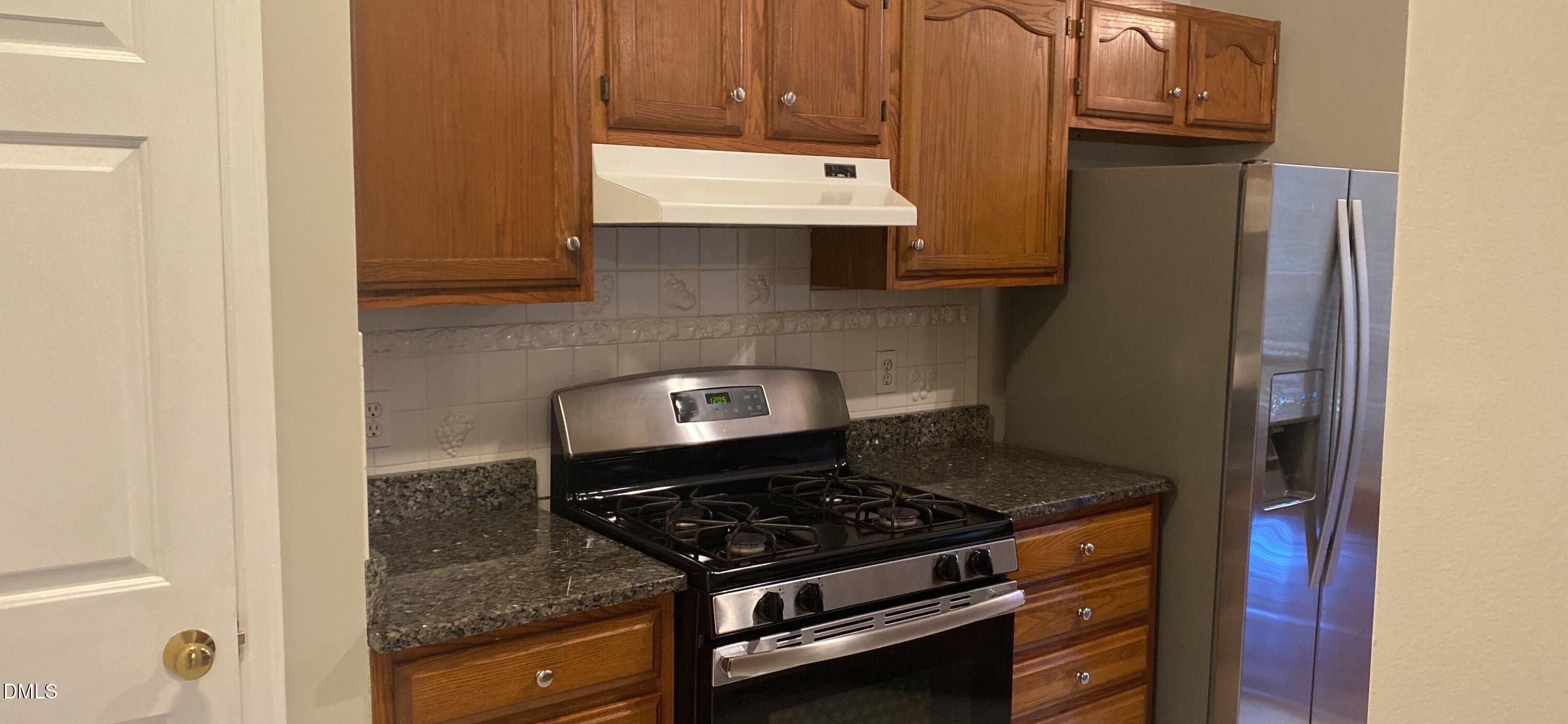 113 Tapestry Terrace Cary, NC 27511 - Photo 2 of 8 a stove top oven sitting inside of a kitchen