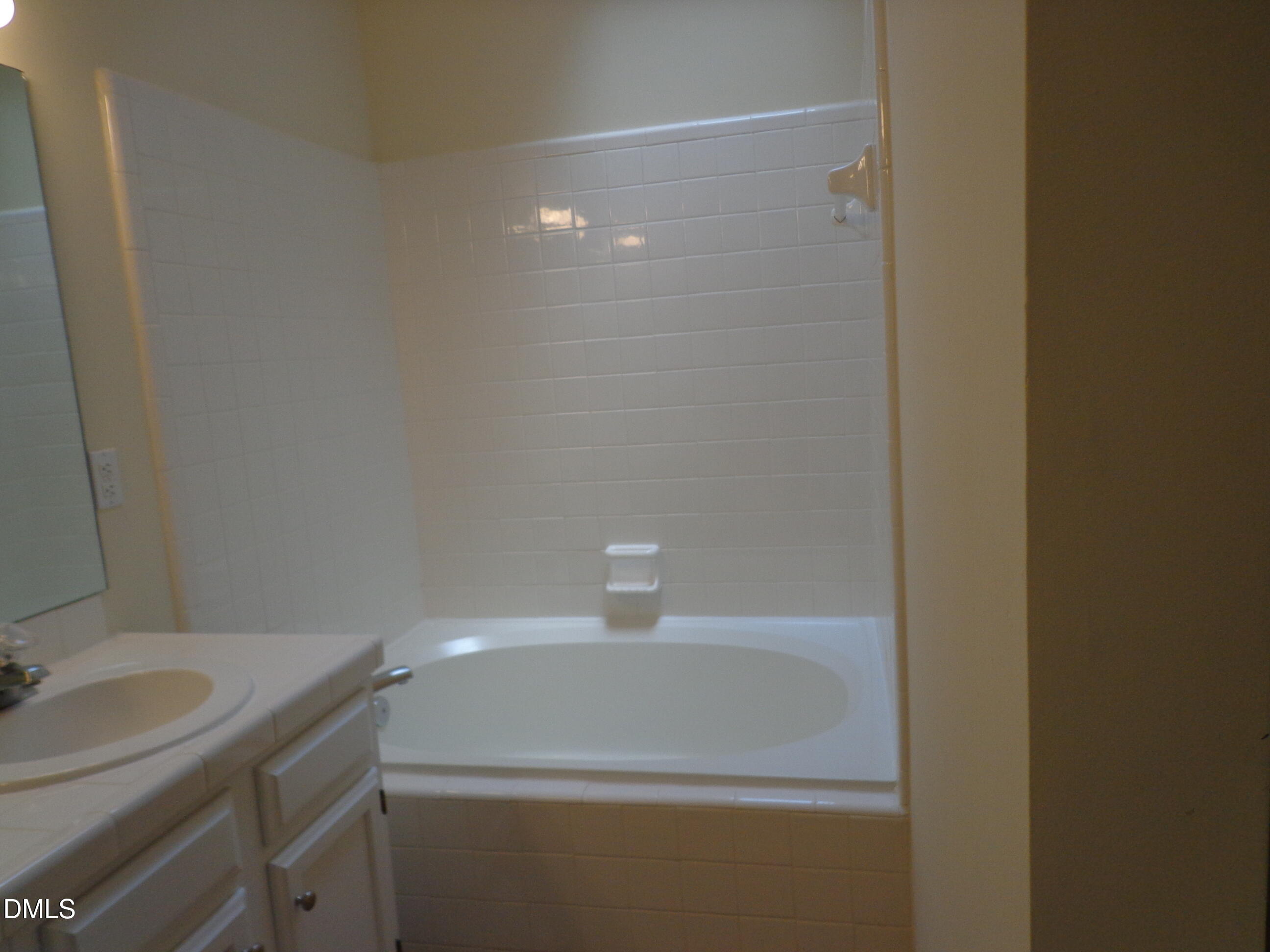 113 Tapestry Terrace Cary, NC 27511 - Photo 4 of 8 a bathroom with a sink and a light fixture