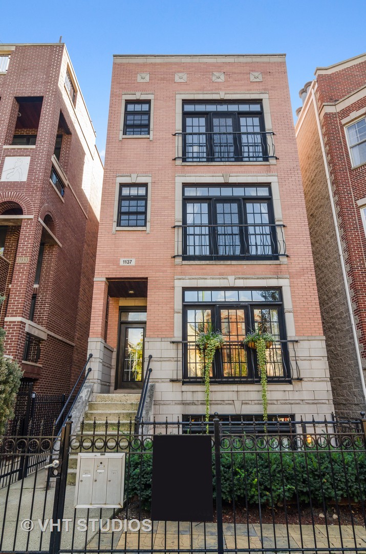 1137 West Addison Street, Unit 2 Chicago, IL 60613 - Photo 1 of 19 a front view of a residential apartment building with a yard