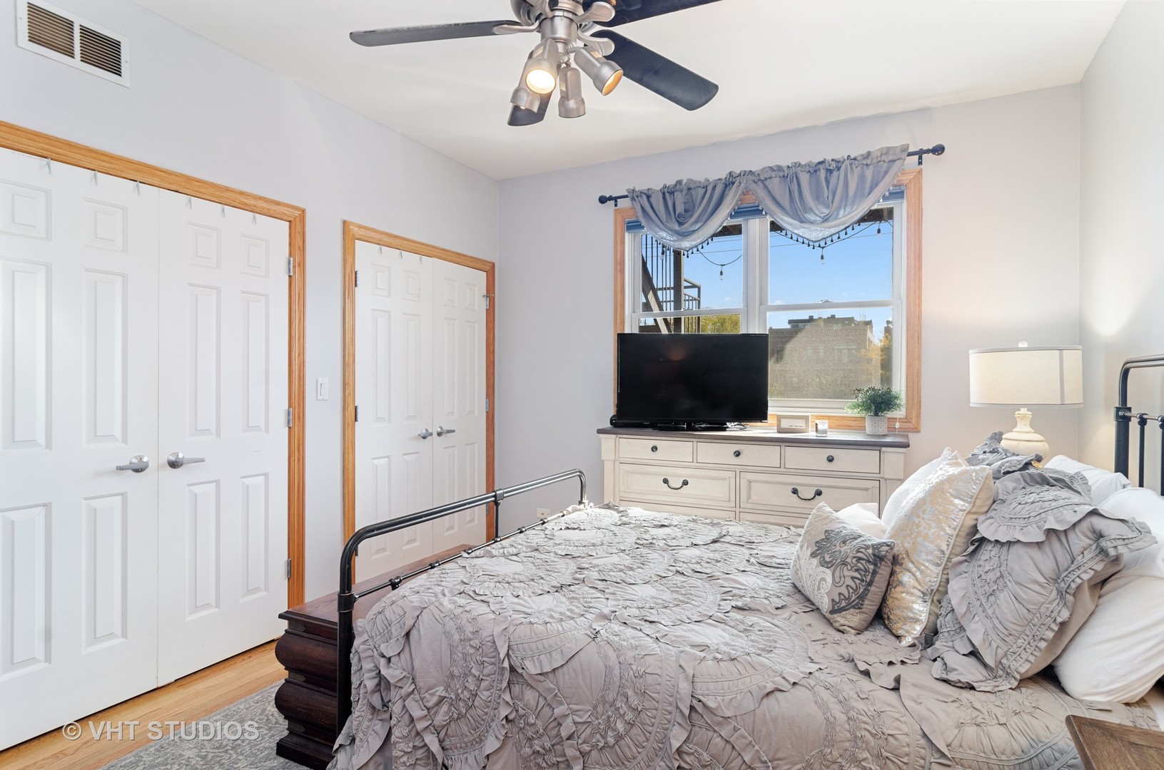 1137 West Addison Street, Unit 2 Chicago, IL 60613 - Photo 11 of 19 a bedroom with a bed and a flat screen tv