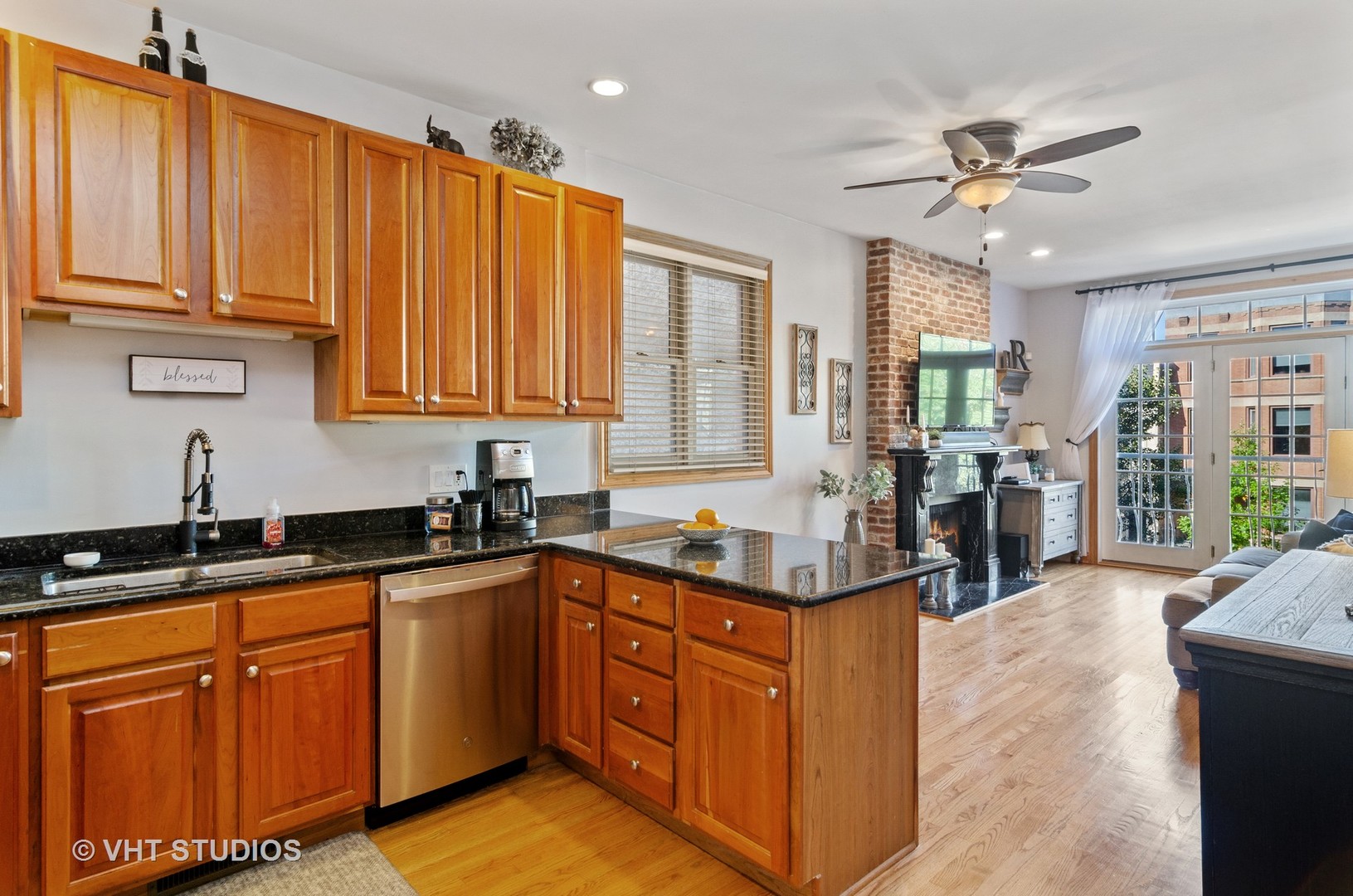 1137 West Addison Street, Unit 2 Chicago, IL 60613 - Photo 19 of 19 a kitchen with stainless steel appliances granite countertop a sink dishwasher stove and cabinets with wooden floor