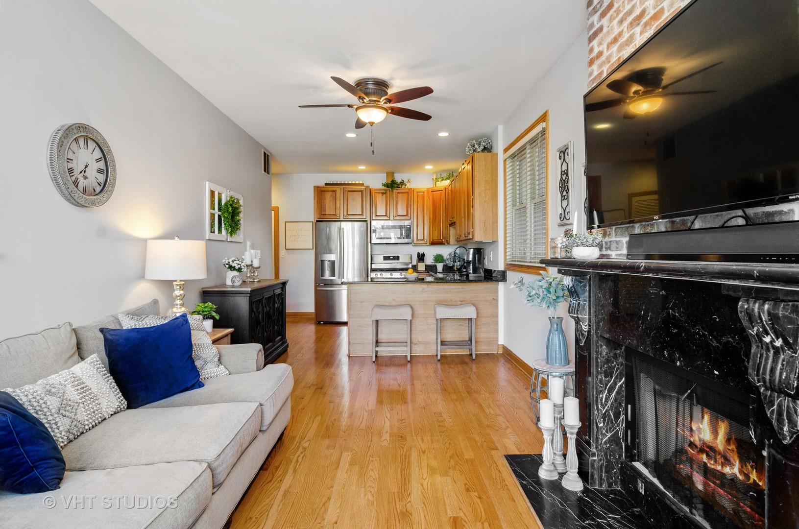 1137 West Addison Street, Unit 2 Chicago, IL 60613 - Photo 3 of 19 a living room with fireplace furniture and a flat screen tv