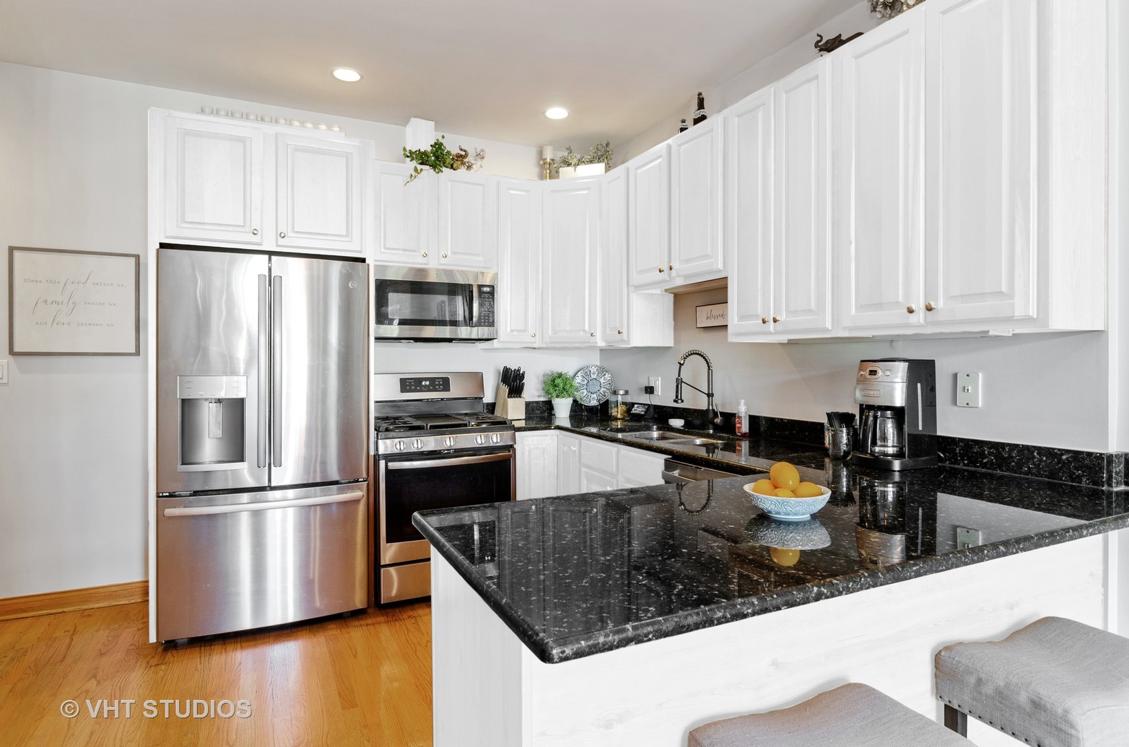 1137 West Addison Street, Unit 2 Chicago, IL 60613 - Photo 6 of 19 a kitchen with stainless steel appliances granite countertop a refrigerator a stove a sink a microwave and white cabinets