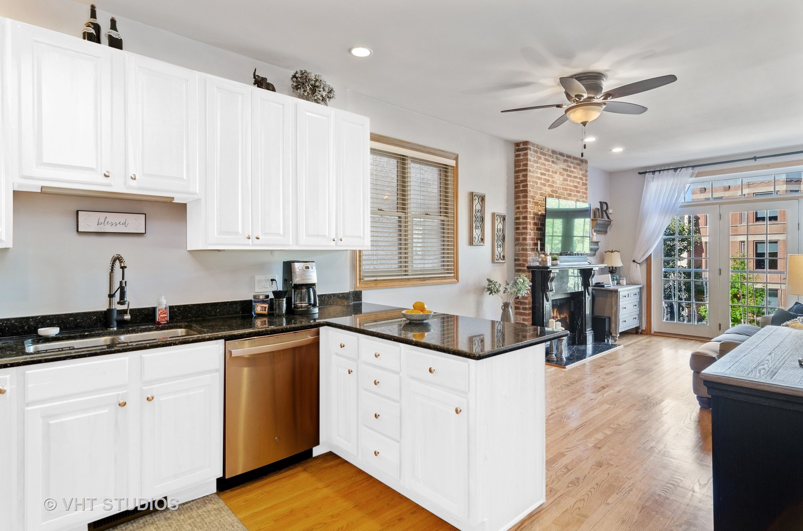 1137 West Addison Street, Unit 2 Chicago, IL 60613 - Photo 7 of 19 a kitchen with granite countertop a sink a stove cabinets and black appliances
