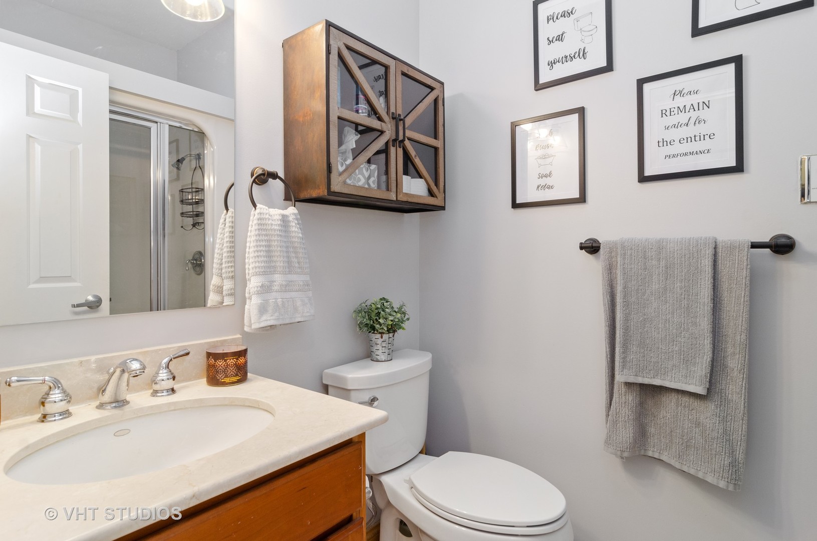 1137 West Addison Street, Unit 2 Chicago, IL 60613 - Photo 9 of 19 a bathroom with a sink mirror vanity and toilet