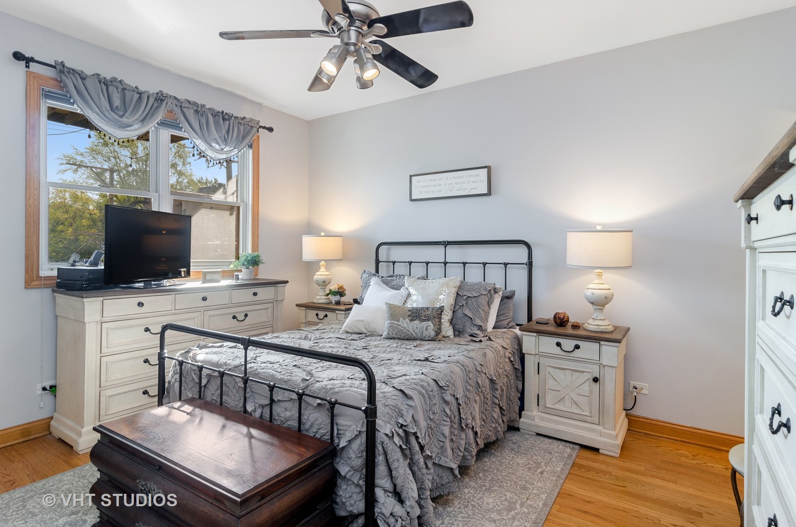 1137 West Addison Street, Unit 2 Chicago, IL 60613 - Photo 10 of 19 a bedroom with a bed and a flat screen tv