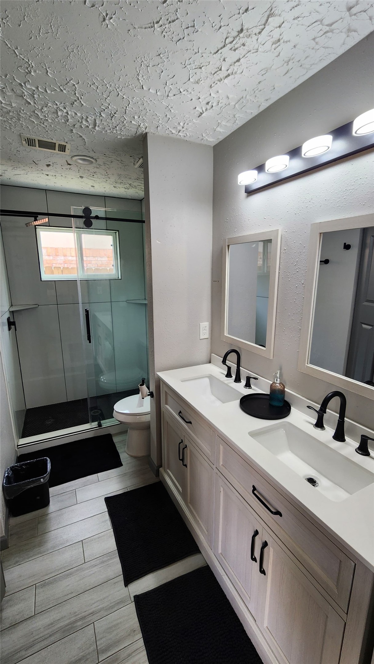 9735 Stonemont Road La Porte, TX 77571 - Photo 10 of 11 a bathroom with a double vanity sink toilet and mirror