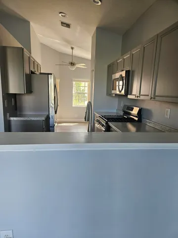 a kitchen with a sink and a refrigerator