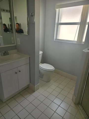 a bathroom with a sink toilet and window
