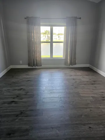 a view of wooden floor and windows in a room