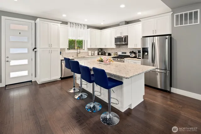 a kitchen with a sink refrigerator and cabinets