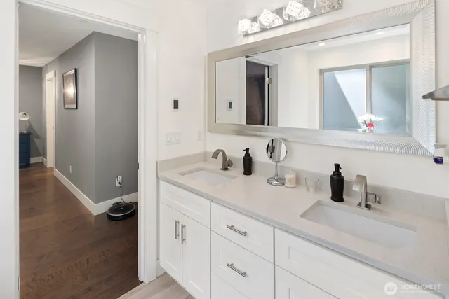 a spacious bathroom with a tub sink a shower and a mirror