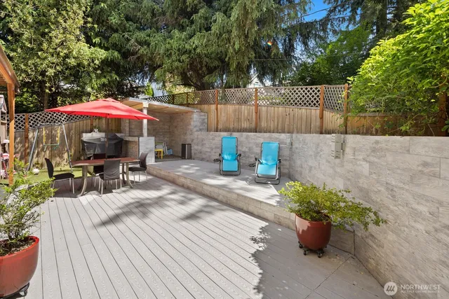 a patio with a table and chairs under an umbrella