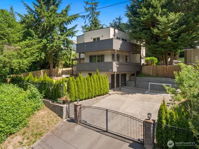 a view of a house with a yard and potted plants