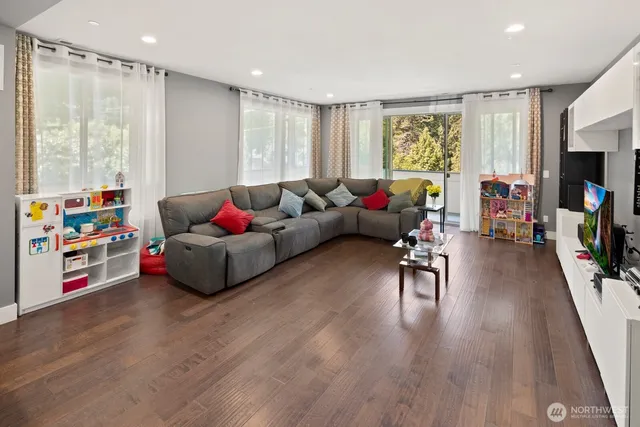 a living room with furniture and wooden floor