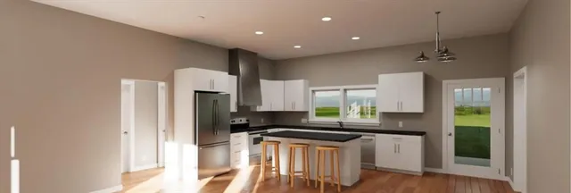 a kitchen with a refrigerator a sink and a stove top oven