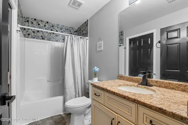 a living room with furniture and a kitchen view