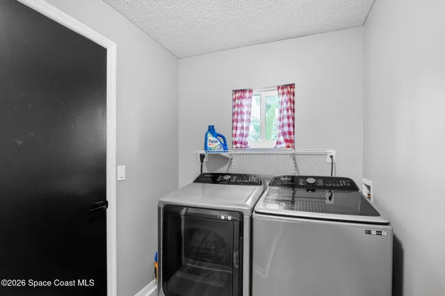 a kitchen with stainless steel appliances granite countertop a stove a refrigerator a sink dishwasher and a dining table with wooden floor