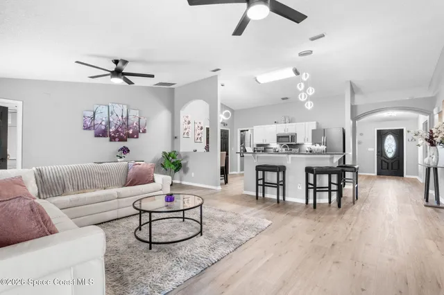 a living room with furniture and wooden floor