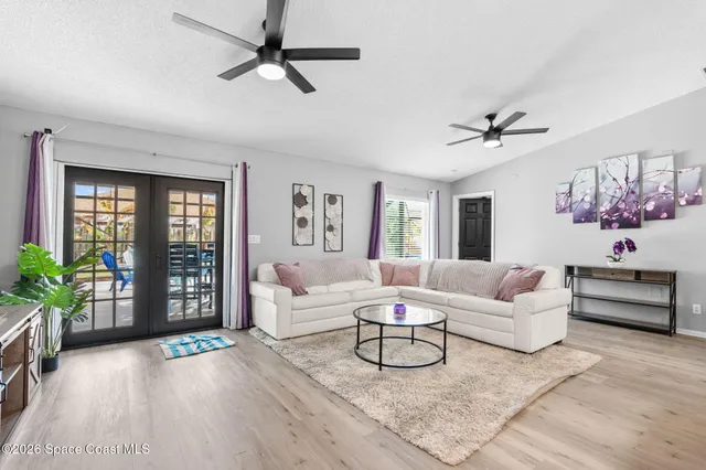 a view of a chairs and table in the back yard of the house