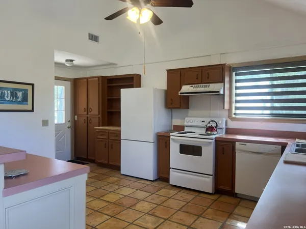 a kitchen that has a sink and a stove