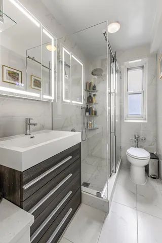 a bathroom with a sink toilet and shower