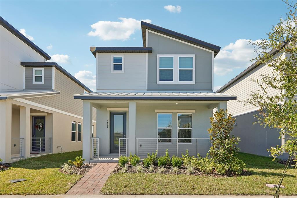 4574 Homestead Trail St. Cloud, FL 34772 - Photo 1 of 31 a front view of a house with garden