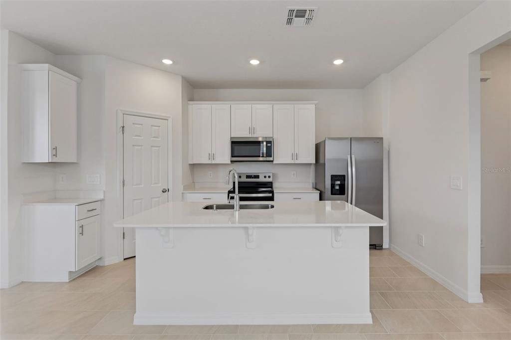 4574 Homestead Trail St. Cloud, FL 34772 - Photo 11 of 31 a large kitchen with cabinets