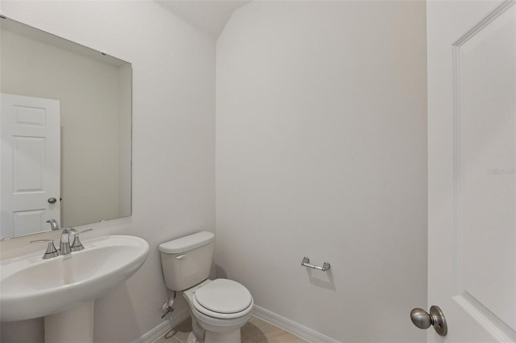 4574 Homestead Trail St. Cloud, FL 34772 - Photo 15 of 31 a bathroom with a toilet a sink a mirror and vanity