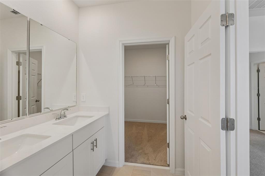 4574 Homestead Trail St. Cloud, FL 34772 - Photo 28 of 31 a bathroom with a shower sink and mirror