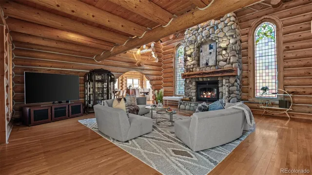 a living room with furniture a flat screen tv and a fireplace