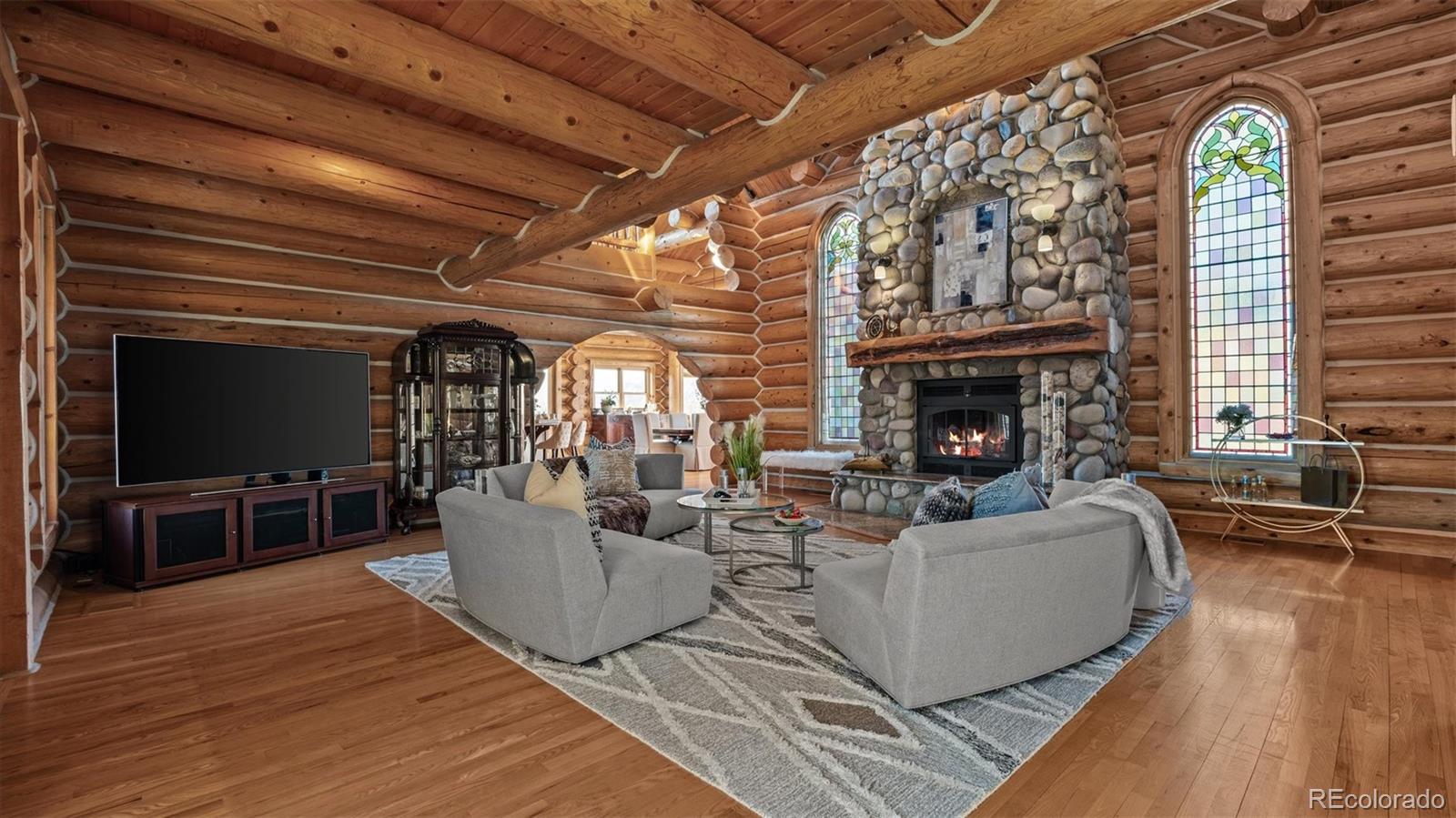3875 F F 3/4 Road Palisade, CO 81526 - Photo 14 of 45 a living room with furniture a flat screen tv and a fireplace