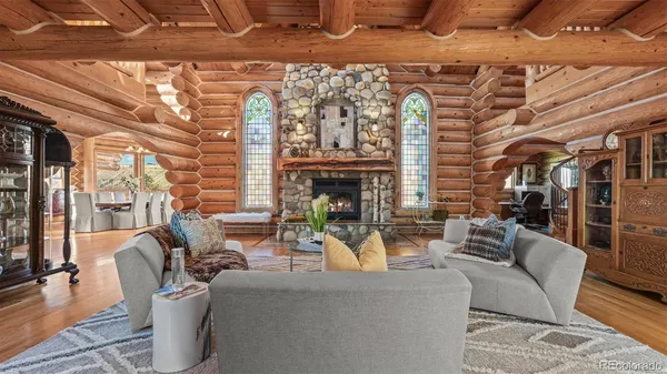 a living room with furniture a fireplace and a table