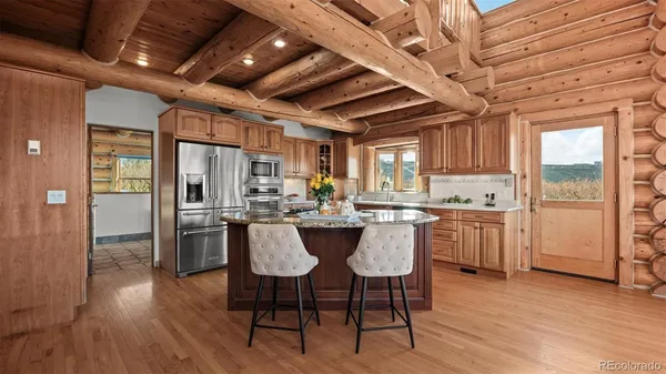 a kitchen with a table chairs refrigerator and cabinets