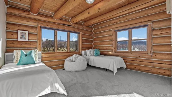 a bedroom with furniture and large windows