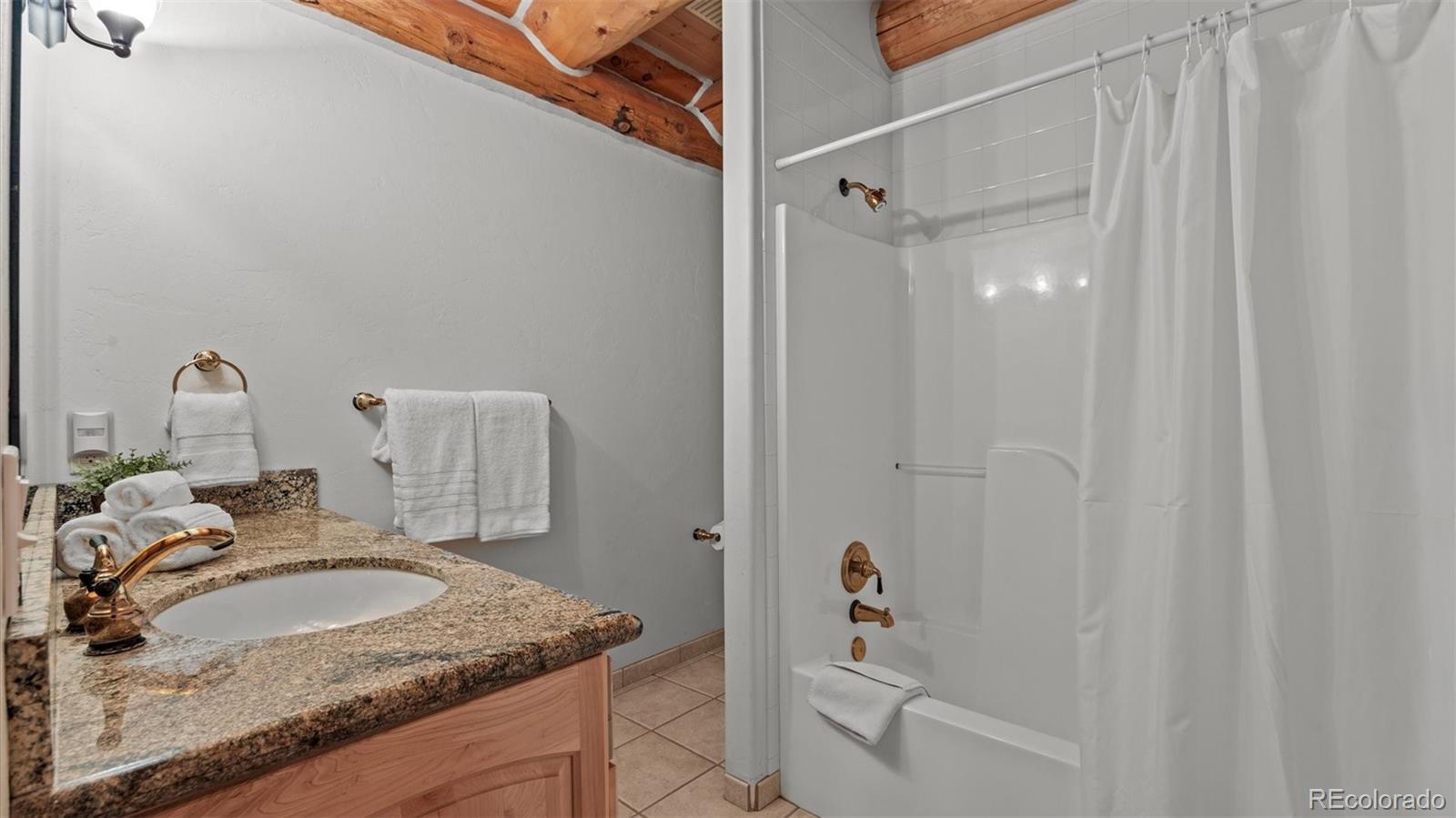 3875 F F 3/4 Road Palisade, CO 81526 - Photo 39 of 45 a bathroom with a granite countertop sink and a mirror