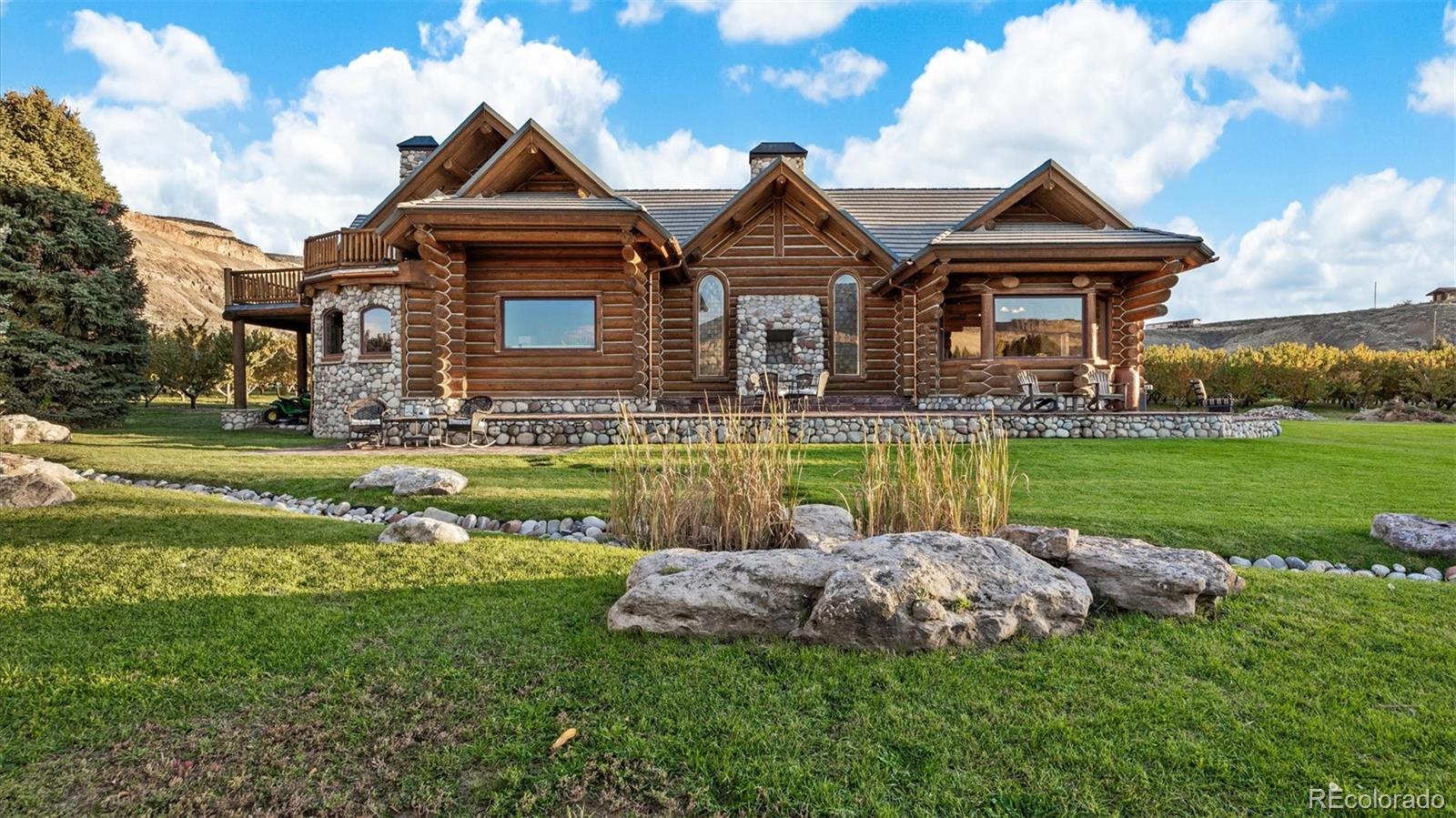 3875 F F 3/4 Road Palisade, CO 81526 - Photo 6 of 45 a front view of a house with a yard