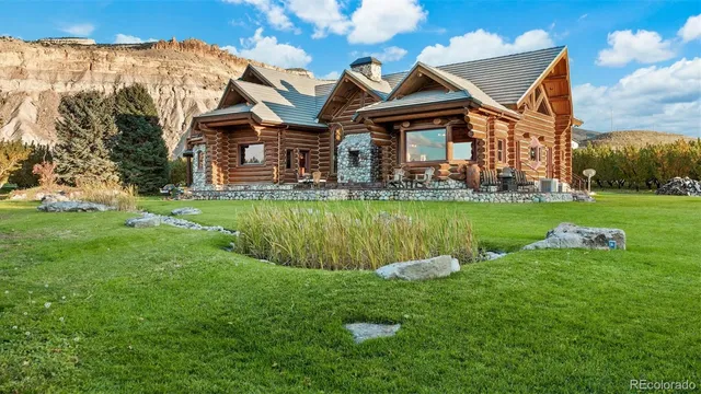a front view of a house with a yard table and chairs