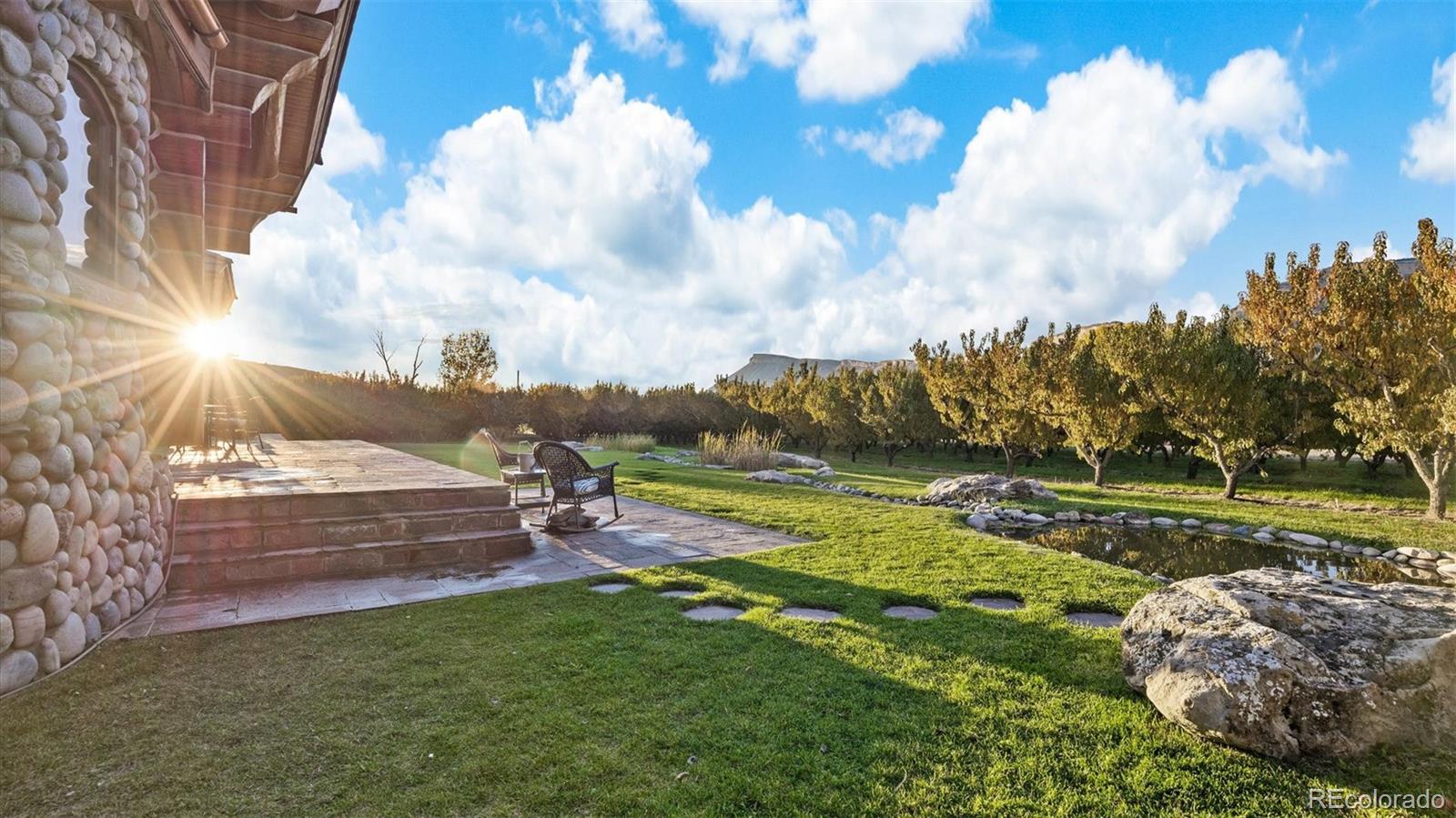 3875 F F 3/4 Road Palisade, CO 81526 - Photo 10 of 45 a view of a golf course with a lake