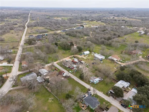 an aerial view of a houses with a yard