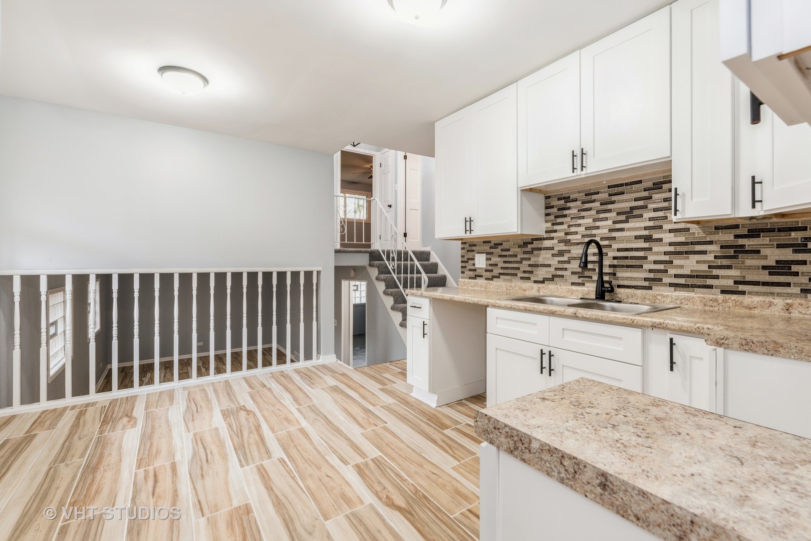 15117 Madison Avenue Dolton, IL 60419 - Photo 3 of 14 a kitchen with stainless steel appliances granite countertop a sink dishwasher a stove and white cabinets with wooden floor