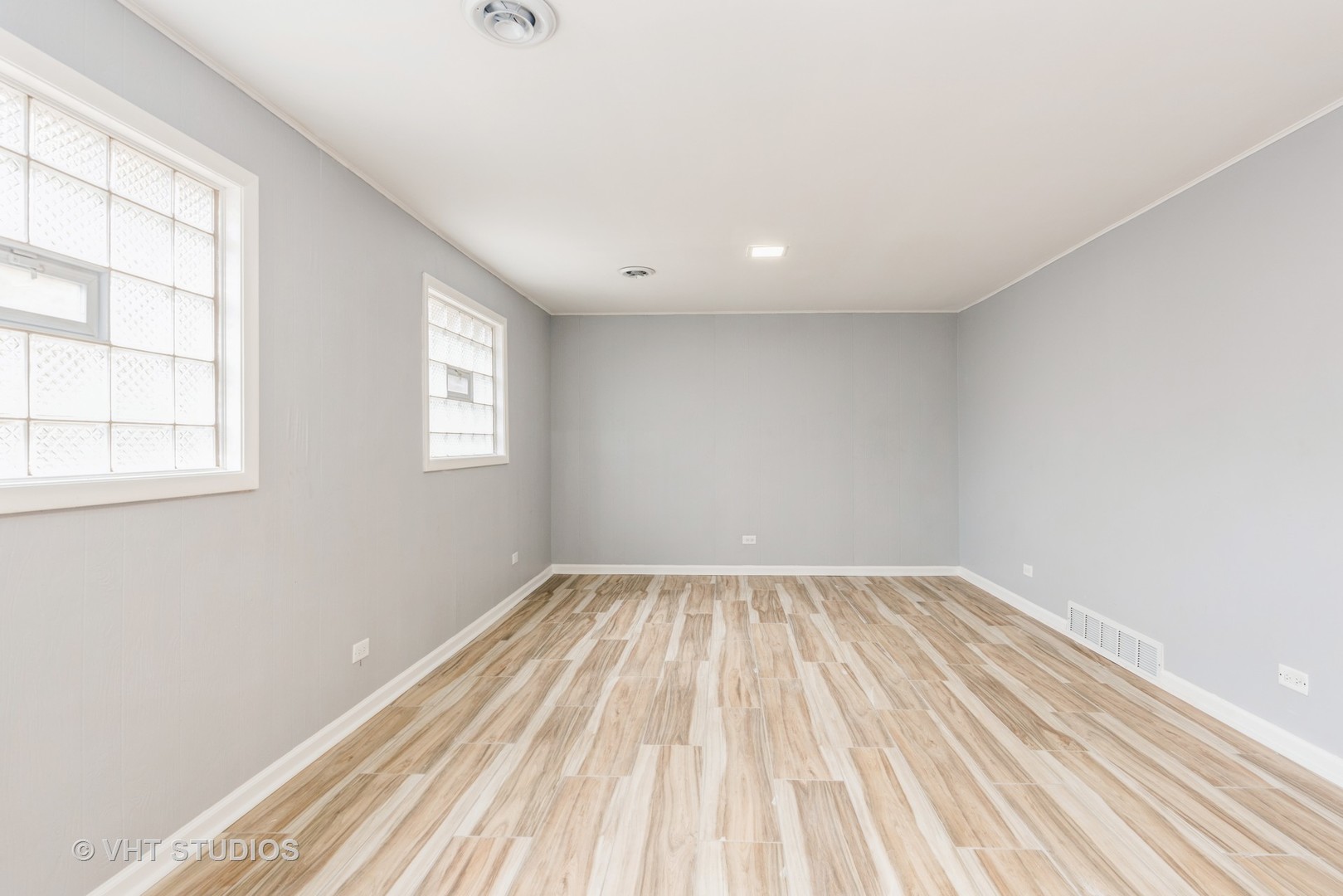 15117 Madison Avenue Dolton, IL 60419 - Photo 9 of 14 an empty room with wooden floor and windows