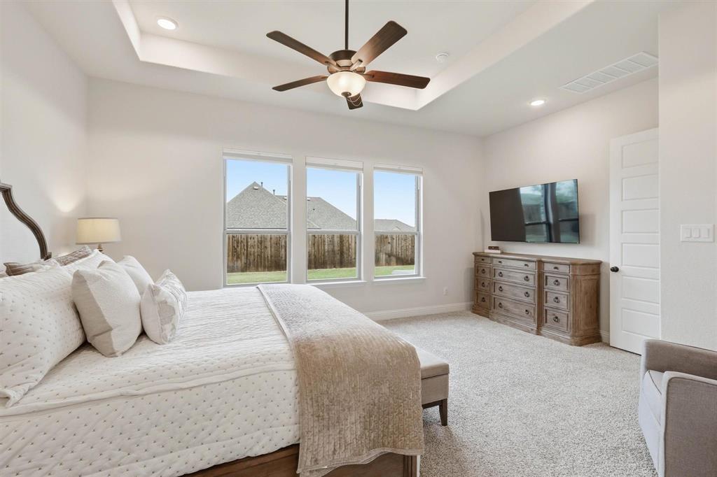 11116 Emory Oak Ridge Flower Mound, TX 76226 - Photo 16 of 40 a bedroom with a bed and a large window