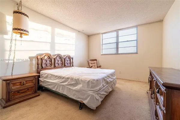 a bedroom with a bed next to a window