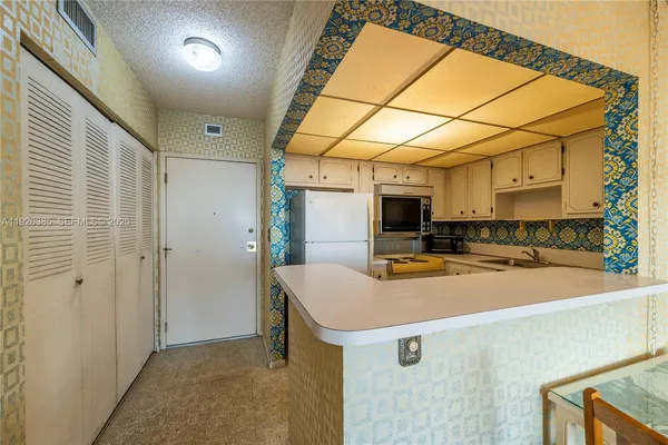 a view of a kitchen with appliances and cabinets