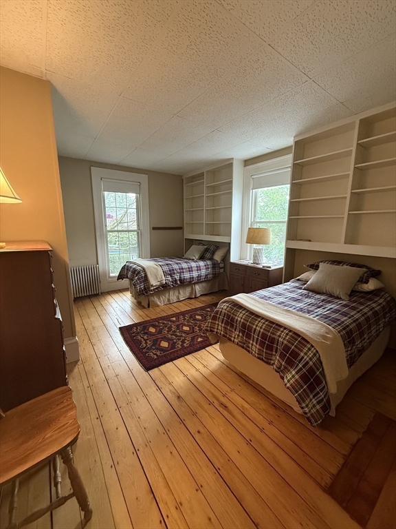 38 Spring Street Somerville, MA 02143 - Photo 13 of 37 a bedroom with bed and window
