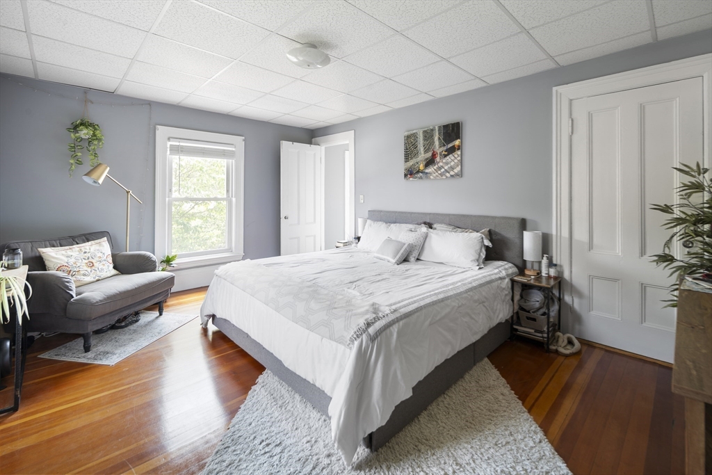 38 Spring Street Somerville, MA 02143 - Photo 20 of 37 a spacious bedroom with a bed and a couch