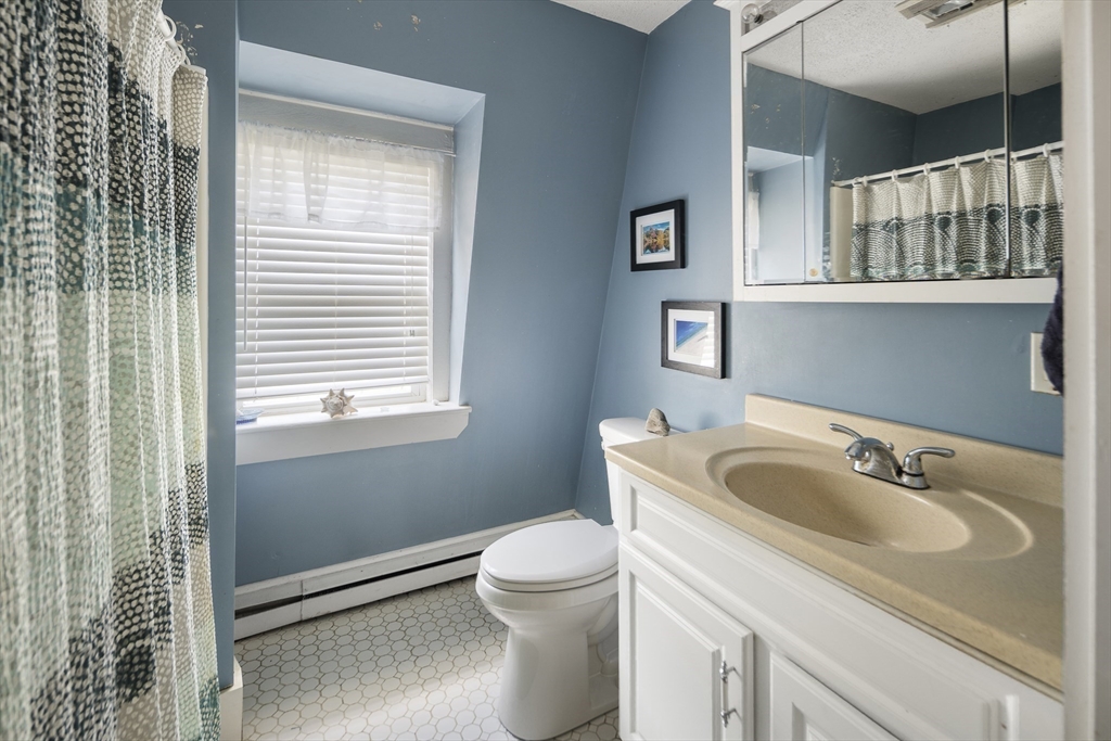 38 Spring Street Somerville, MA 02143 - Photo 21 of 37 a bathroom with a toilet sink and mirror