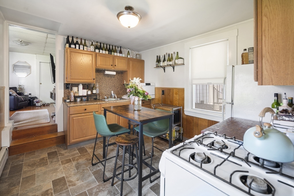 38 Spring Street Somerville, MA 02143 - Photo 22 of 37 a dining room with furniture and a large window