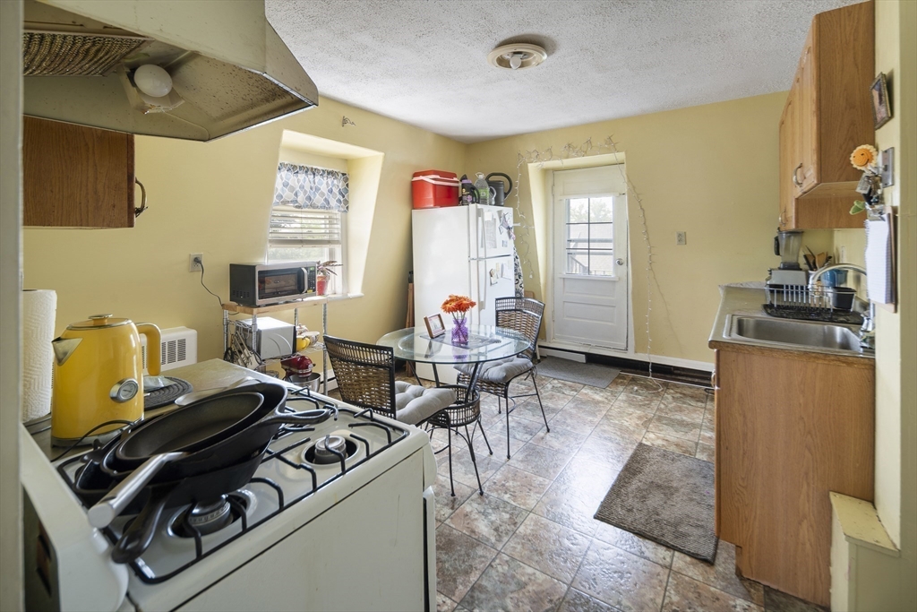 38 Spring Street Somerville, MA 02143 - Photo 25 of 37 a living room with furniture and a flat screen tv